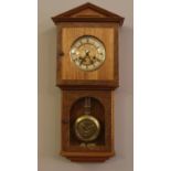 A Oak cased pendulum wall clock. (68cm height, 23cm width)