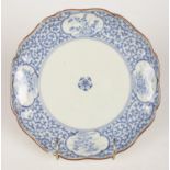 An 18th Century oriental blue and white decorated plate with gilt edging. Mark on the reverse.