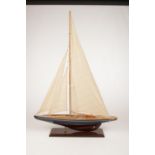 A large wooden model of a sail boat. (Height 85cm).