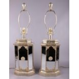 A pair of ornate hammered brass effect and mirrored table lamps. (69cm tall)