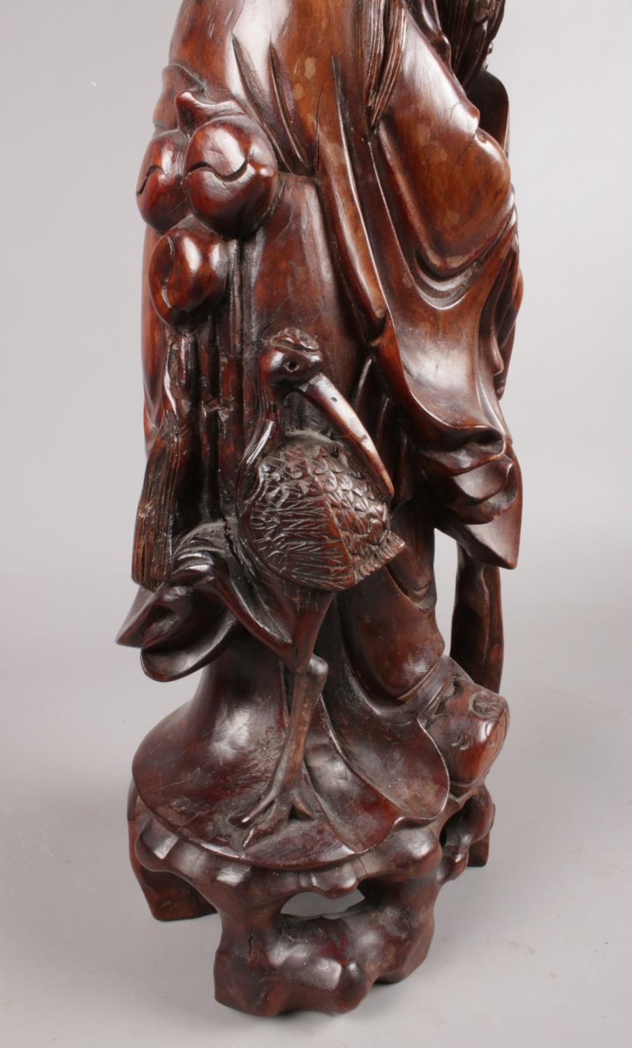 A hardwood oriental carved figure depicting a sage figure with scroll. This figure has ivory - Image 4 of 4