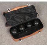 A set of four Henselite lawn bowls, in carry bag.