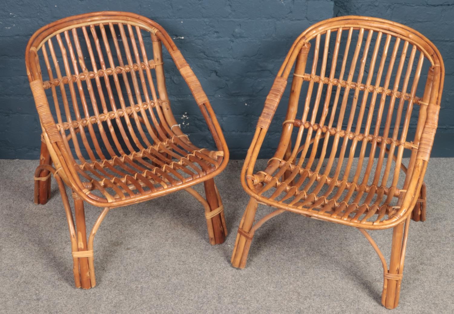 A pair of wicker and bamboo conservatory chairs.