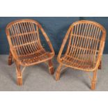 A pair of wicker and bamboo conservatory chairs.