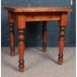 A stained square Pine kitchen table with turned legs. H: 80cm, W:76.5cm, D:76cm. Condition fair,
