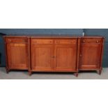 A good quality Regency style figured mahogany breakfront sideboard - comprising of 3 cupboards and 4