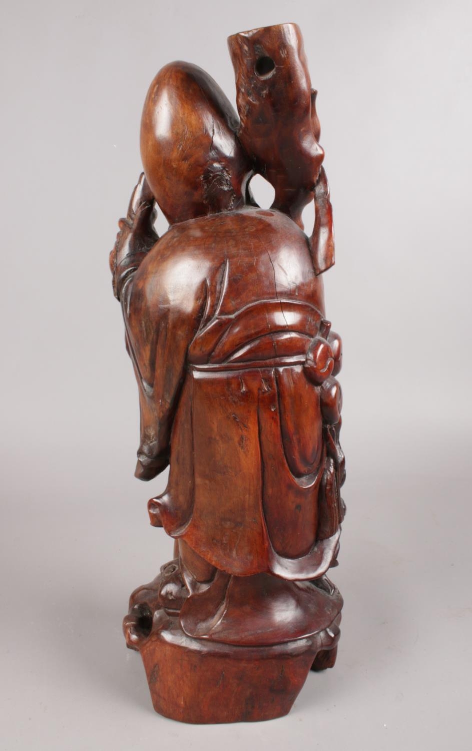 A hardwood oriental carved figure depicting a sage figure with scroll. This figure has ivory - Image 2 of 4