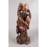 A hardwood oriental carved figure depicting a sage figure with scroll. This figure has ivory