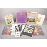 A group of collectables - comprising a selection of stamp book leafs with stamps from Japan, Kenya &