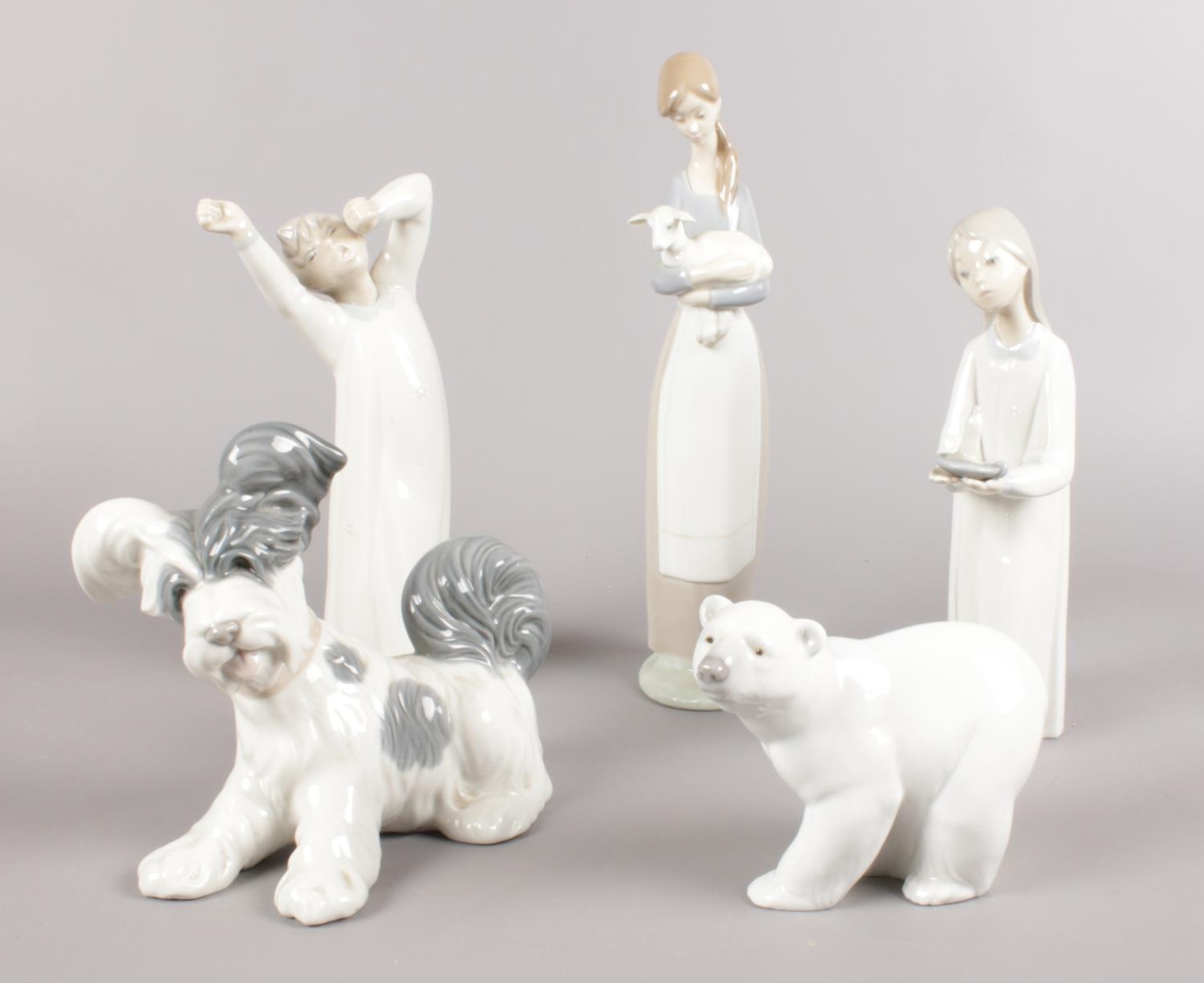 Five Lladro figures. Polar Bear, dog, girl walking with candlestick examples etc. (28cm tallest)