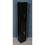 A black steel gun cabinet. Dual locking with interior lockable compartment. (Height 145cm Width 25cm