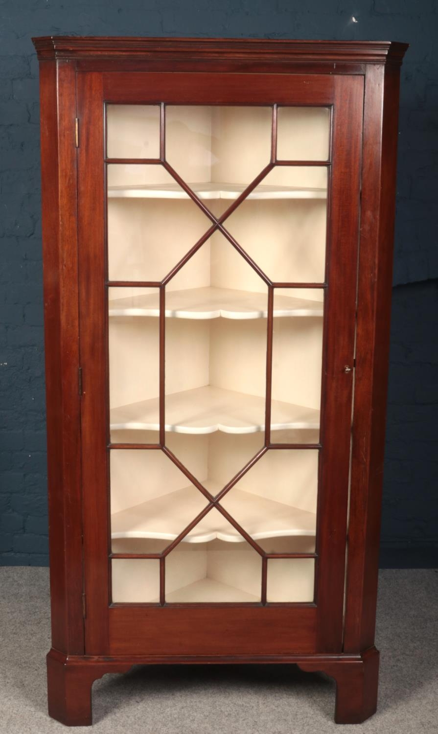 A large Victorian mahogany astragal glazed corner cupboard. (Height 199cm Width 100cm Depth 59cm).