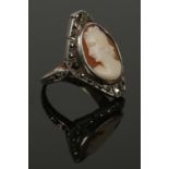 A 9ct gold and silver marcasite cameo ring. Size