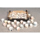 A box of commemorative mugs. Includes antique examples.
