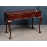 A Mahogany 2 drawer writing table with cabriole legs & ball claw feet. (furniture makers stamp to