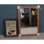An Atsonea gilt bevelled mirror together with a framed sampler. Mirror: H: 88cm, W: 63cm. Sampler: