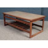 A teak coffee table. With tiled top and slatted under tier. Crack to two tiles.