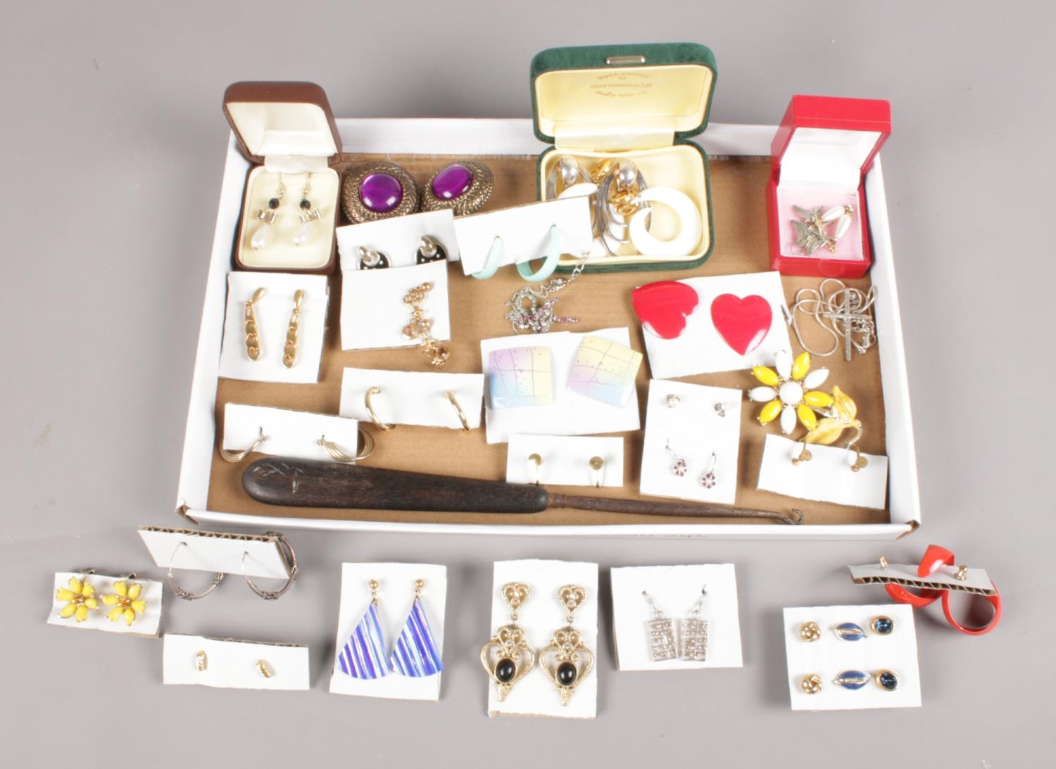 A collection of mainly costume jewellery. Includes earrings, ebony handled button hook, necklaces