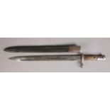 An early 20th century bayonet with leather scabbard. (Blade Length 37cm). Blade heavily pitted.