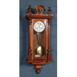 A carved mahogany eight day wall clock. Chiming on a coiled gong. Missing finials.