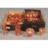 Two boxes of orange carnival glass. Vases, bowls examples etc