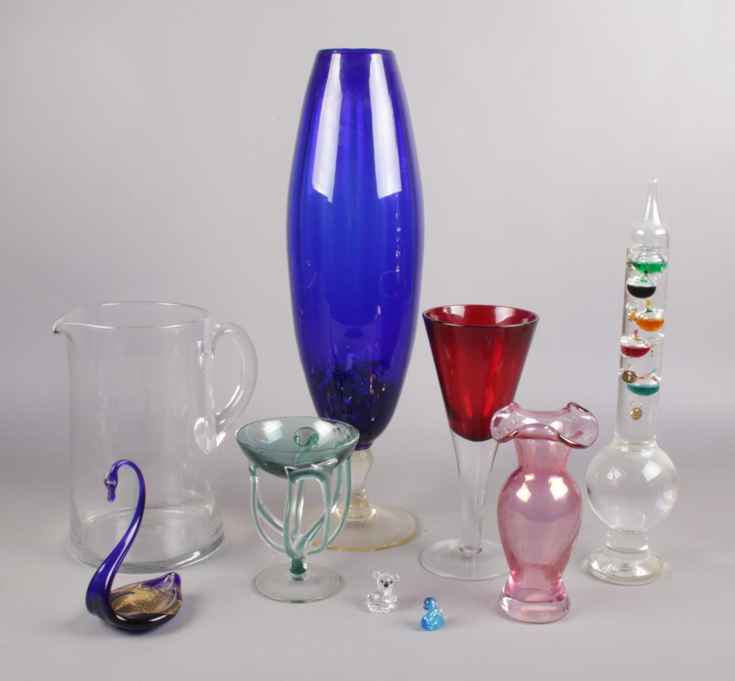 A collection of art glass. Includes Whitefriars jug, large blue glass vase etc.