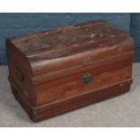 A dome top twin handled tin trunk.