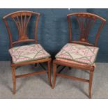 A pair of Edwardian inlaid mahogany pierced back nursing chairs.