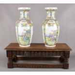 A pair of decorative oriental vases, with carved oak stool. (Vase height 44.5cm).