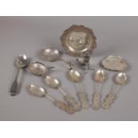 A collection of silver items, five Chinese tea spoons each with Shou roundels, Cornucopia pepper