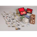 A group of collectables. Includes filigree box, collector's spoons, thimbles, miniature musical