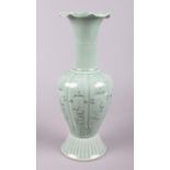 A Chinese celadon coloured vase. Character marks to the base. (Height 26cm).