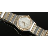 A ladies Omega bi metal Constellation quartz wristwatch. With diamond set bezel and satin dial.