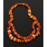 An opera polished amber necklace comprising of cognac, butterscotch and blonde amber with screw