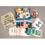 A collection of Beatles memorabilia. Includes records, 1960s bubble gum cards etc.