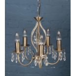 A 5 arm chandelier with crystal style droplets.