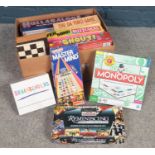 A box of assorted board games. Monopoly, Mastermind, Shout examples etc