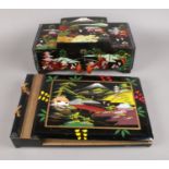 A Japanned musical jewellery box and matching album.