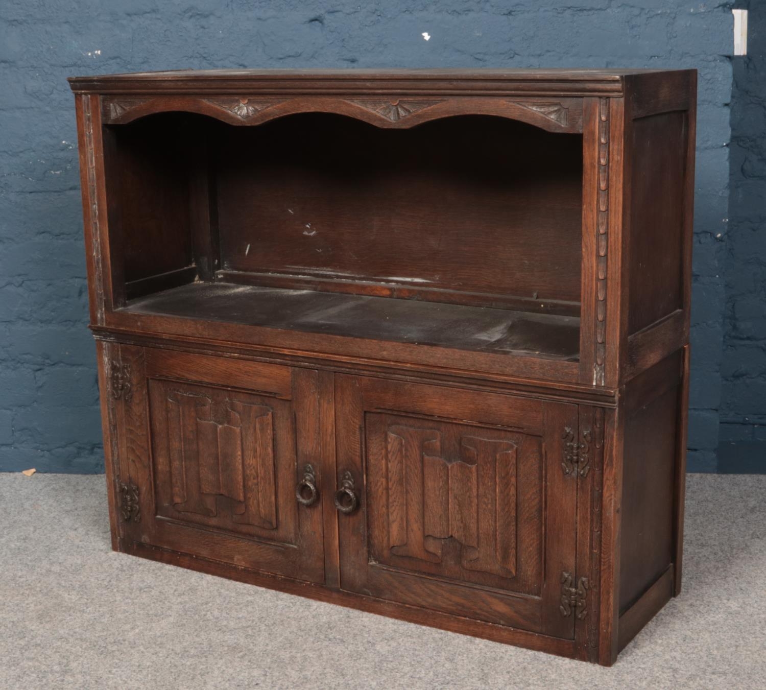 Two carved and panelled oak units. Including one cupboard example with linen fold decoration.