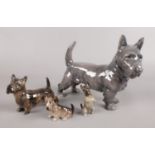 A collection of ceramic Scottish Terrier dogs. Includes three Royal Doulton and one Royal Copenhagen