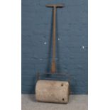 A vintage cast iron and heavy concreate garden roller. H: 140cm, W:44.5cm. Condition age worn.