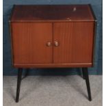 A retro mahogany side cabinet with fitted interior and painted legs.