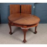A large Mahogany extending dining table with ball & claw feet. Comprising of carved upper legs, D