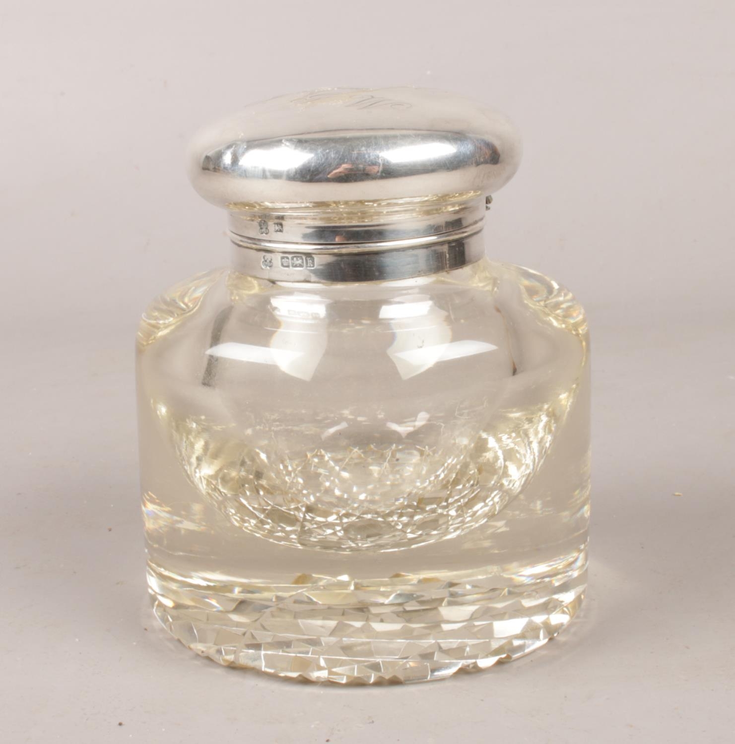 A silver topped glass ink well. Assayed Sheffield 1902 by Boardman, Glossop & Co Ltd. Hinge pin