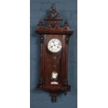 A Victorian eight day wall clock with Jungian's movement chiming on a coiled gong.