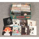 A box of 1980s single records.