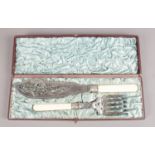 A cased silver plate fish knife and fork with bone handle and pierced decoration.
