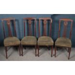 A set of four Victorian mahogany dining chairs. With carved floral backs.