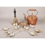 A group of metalwares. Includes copper kettle, hand bell, Mappin & Webb spoons, wine coaster.