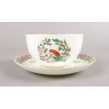 A Royal Worcester hand-painted small bowl and saucer. Decorated in the Worcester parrot pattern with